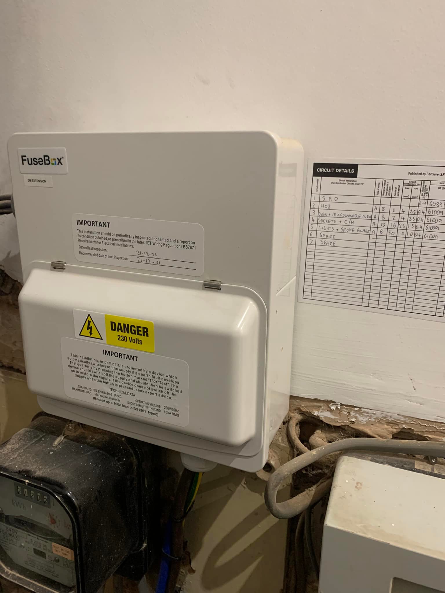 White fuse box with danger 230 volts yellow warning triangle