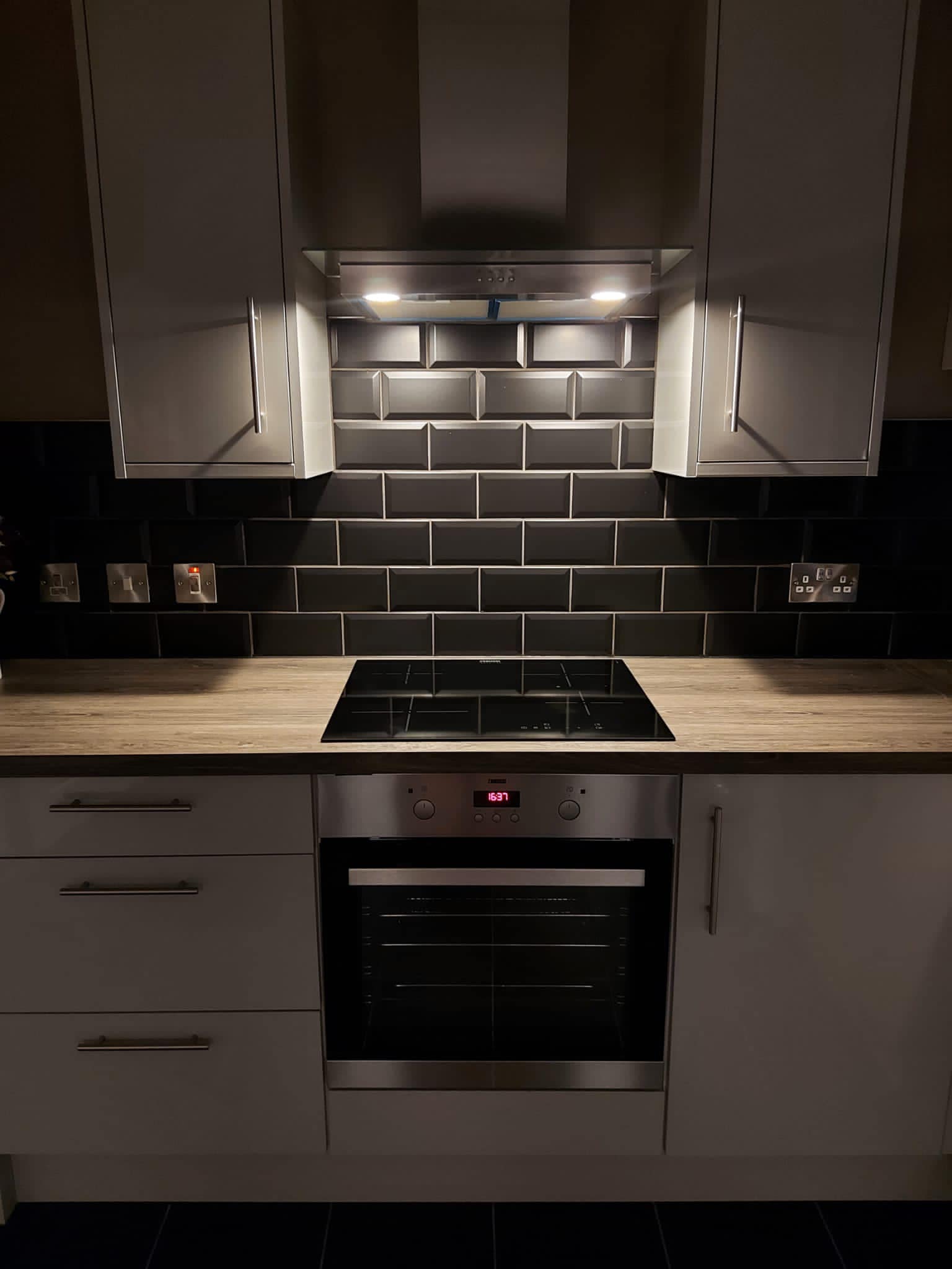 Kitchen work top with oven in the middle and LED lighting above